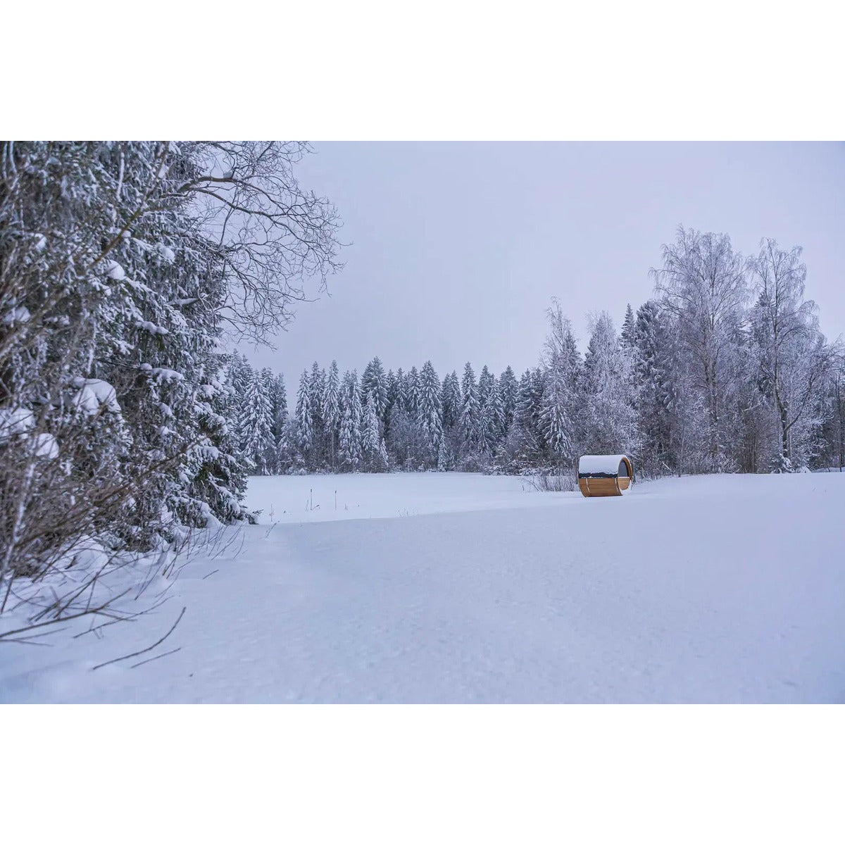 Winter landscape lifestyle image used for Hekla Barrel Sauna 210 marketing.