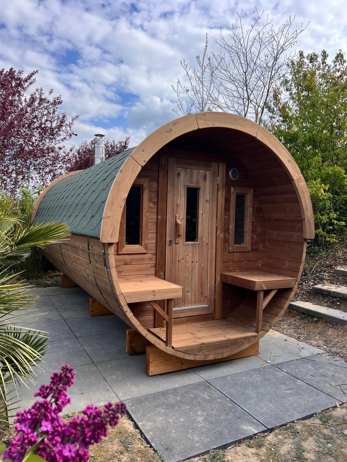 Holvi 480 with green shingle roof and terrace benches on a paved base