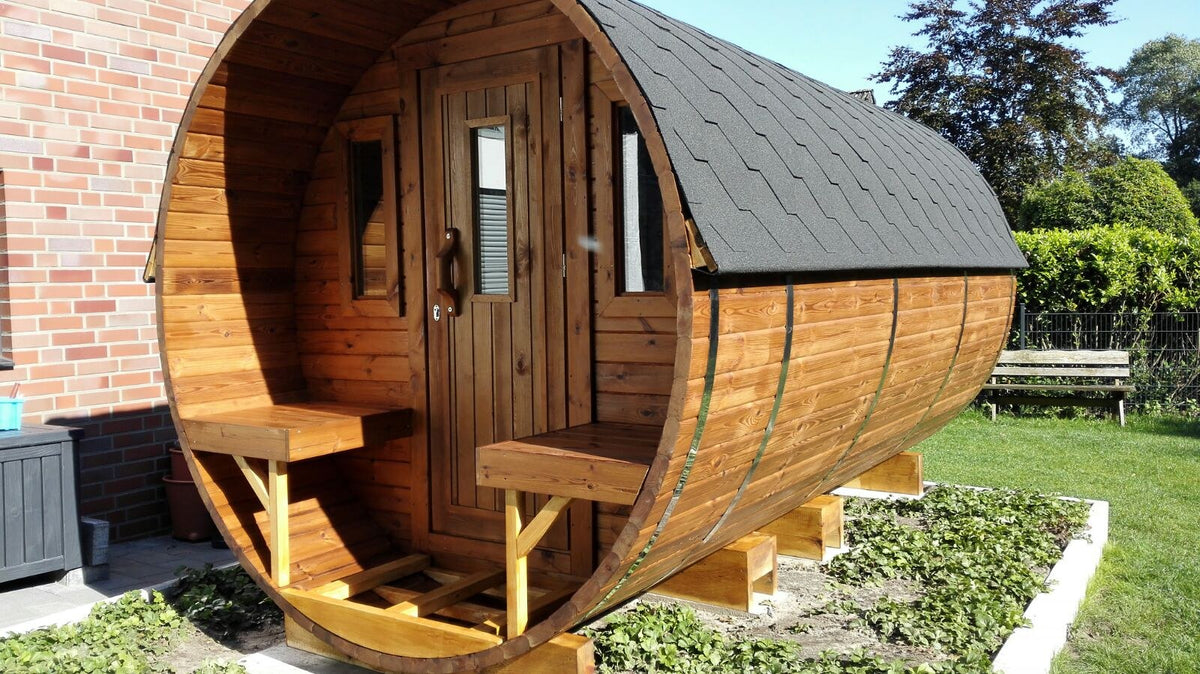 Holvi 450 with terrace benches either side of the door and black shingle roof