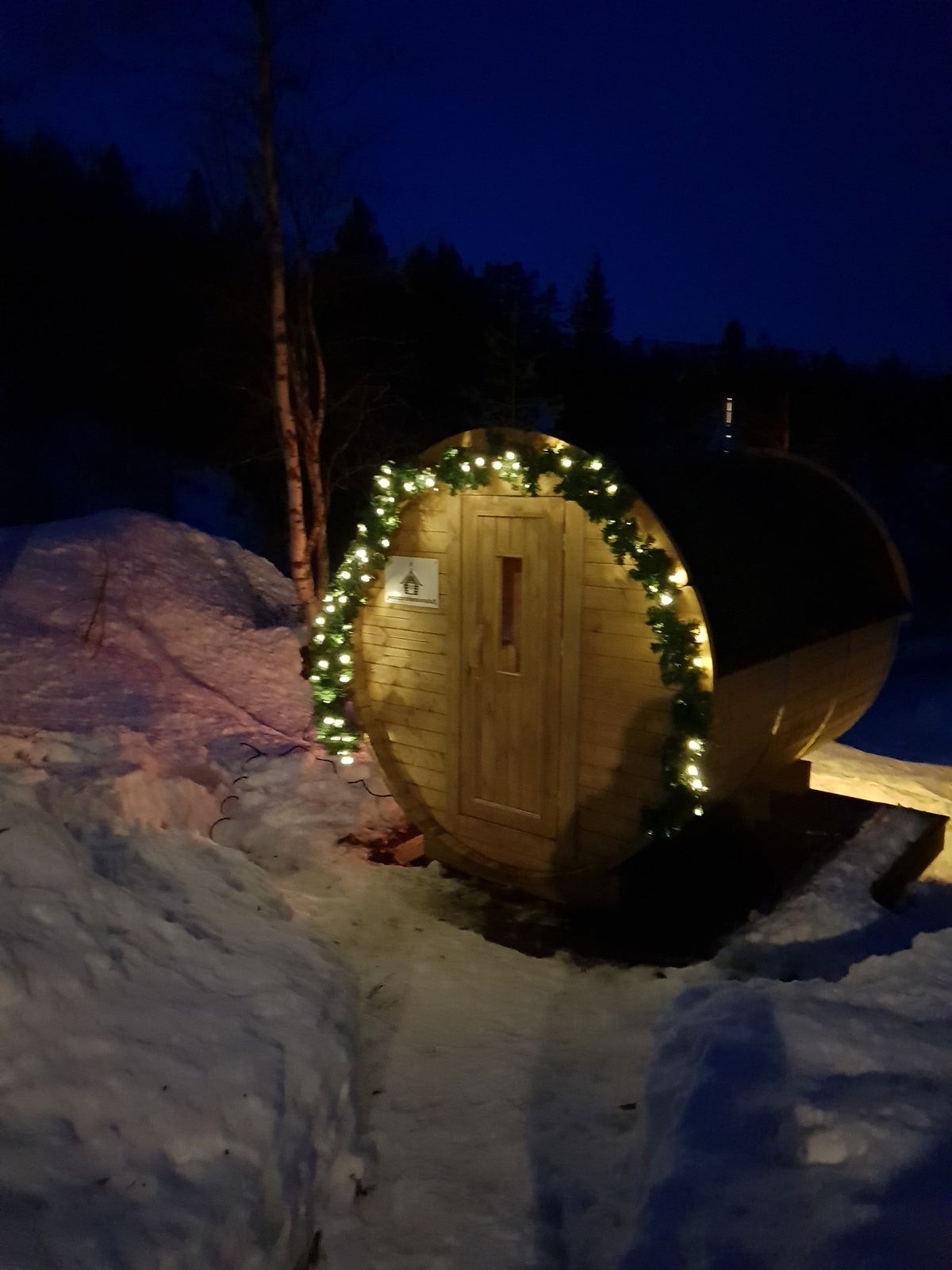 Holvi 170 barrel sauna at night in the snow