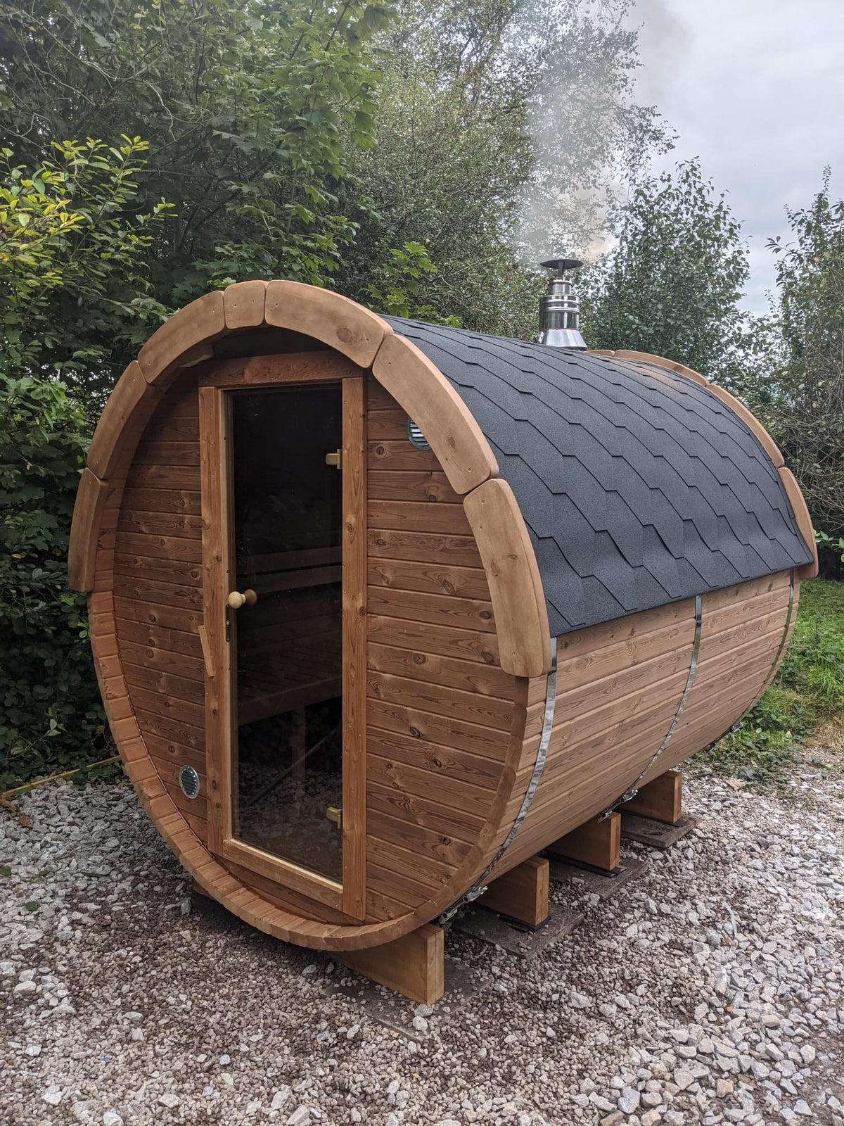 Holvi 240 with glass door, three quarter view on a gravel base