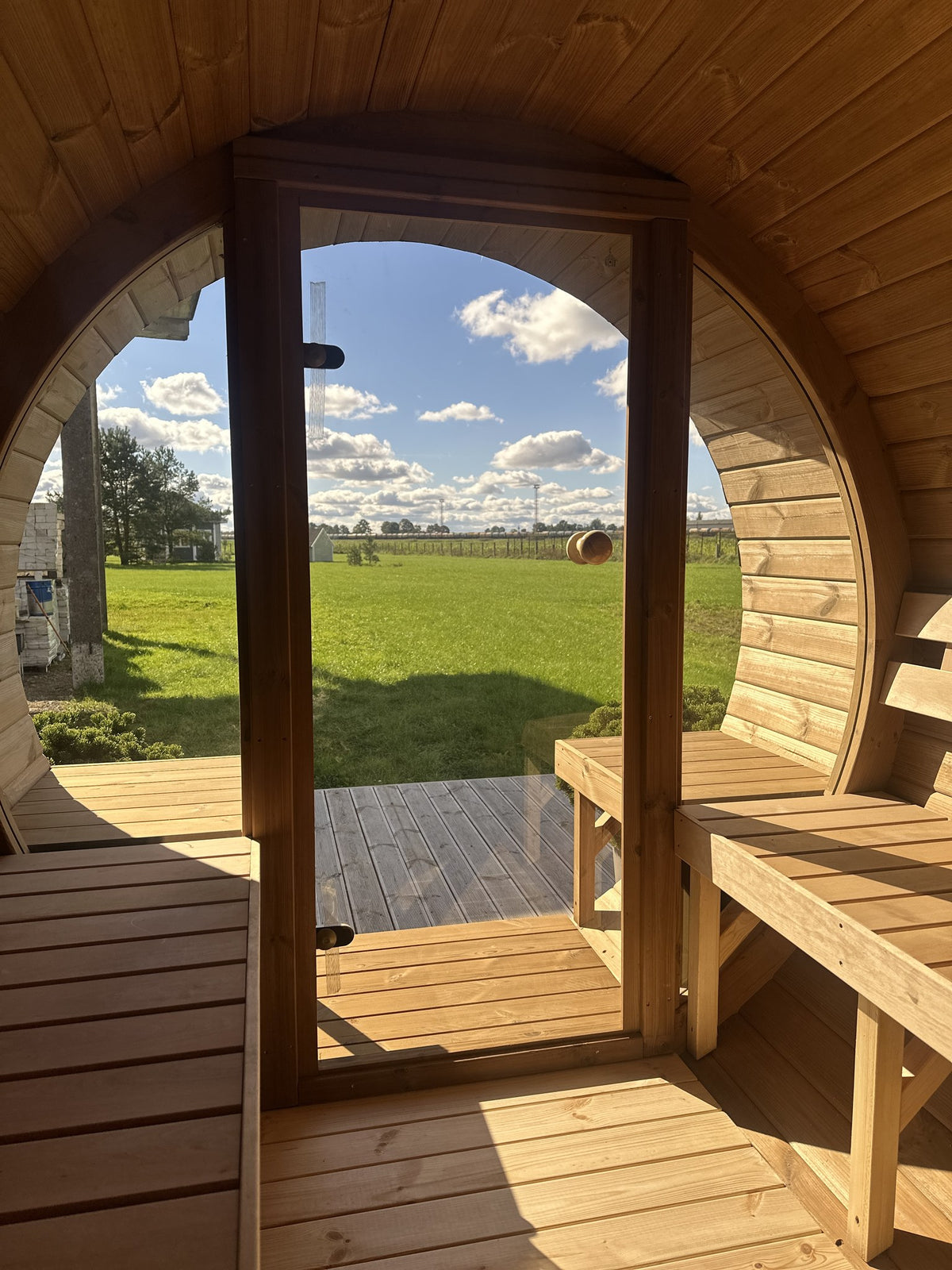 View out through a tinted glass door to the terrace benches