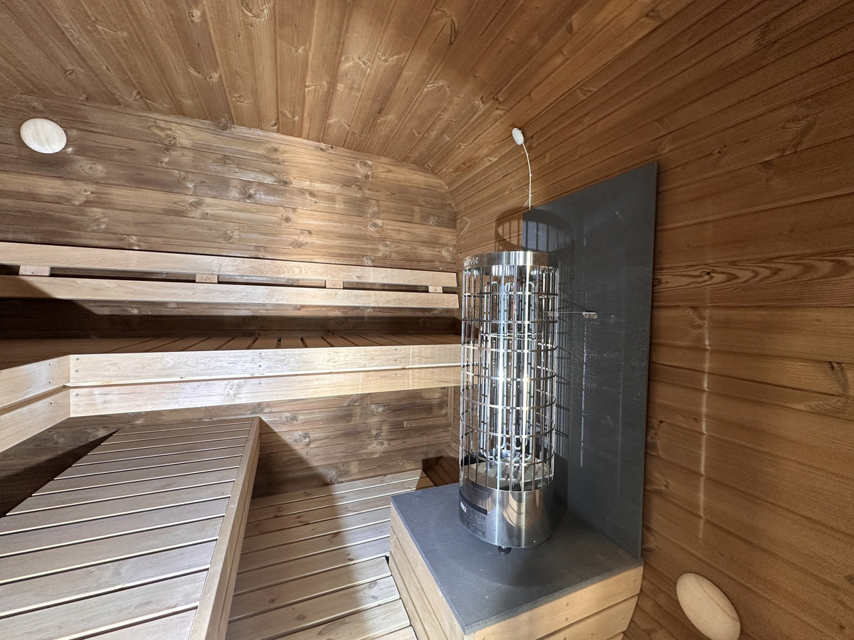 Ruutu 230 interior with Harvia Cilindro heater, shown with optional L shaped benches