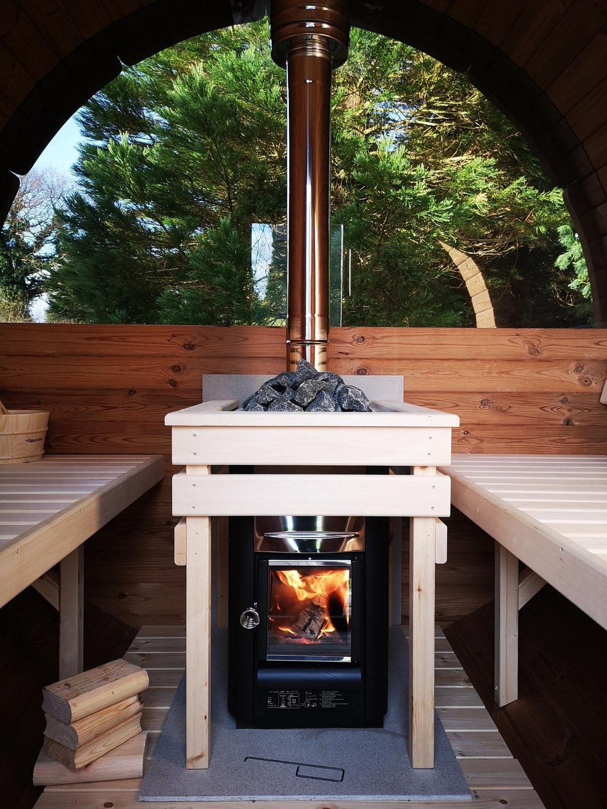 Holvi 240 interior with the wood fired stove between the benches