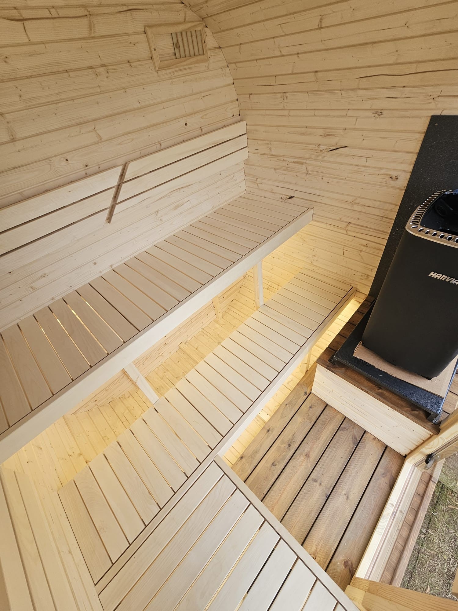 Cube Sauna 2m interior with Harvia heater and L-shaped bench arrangement