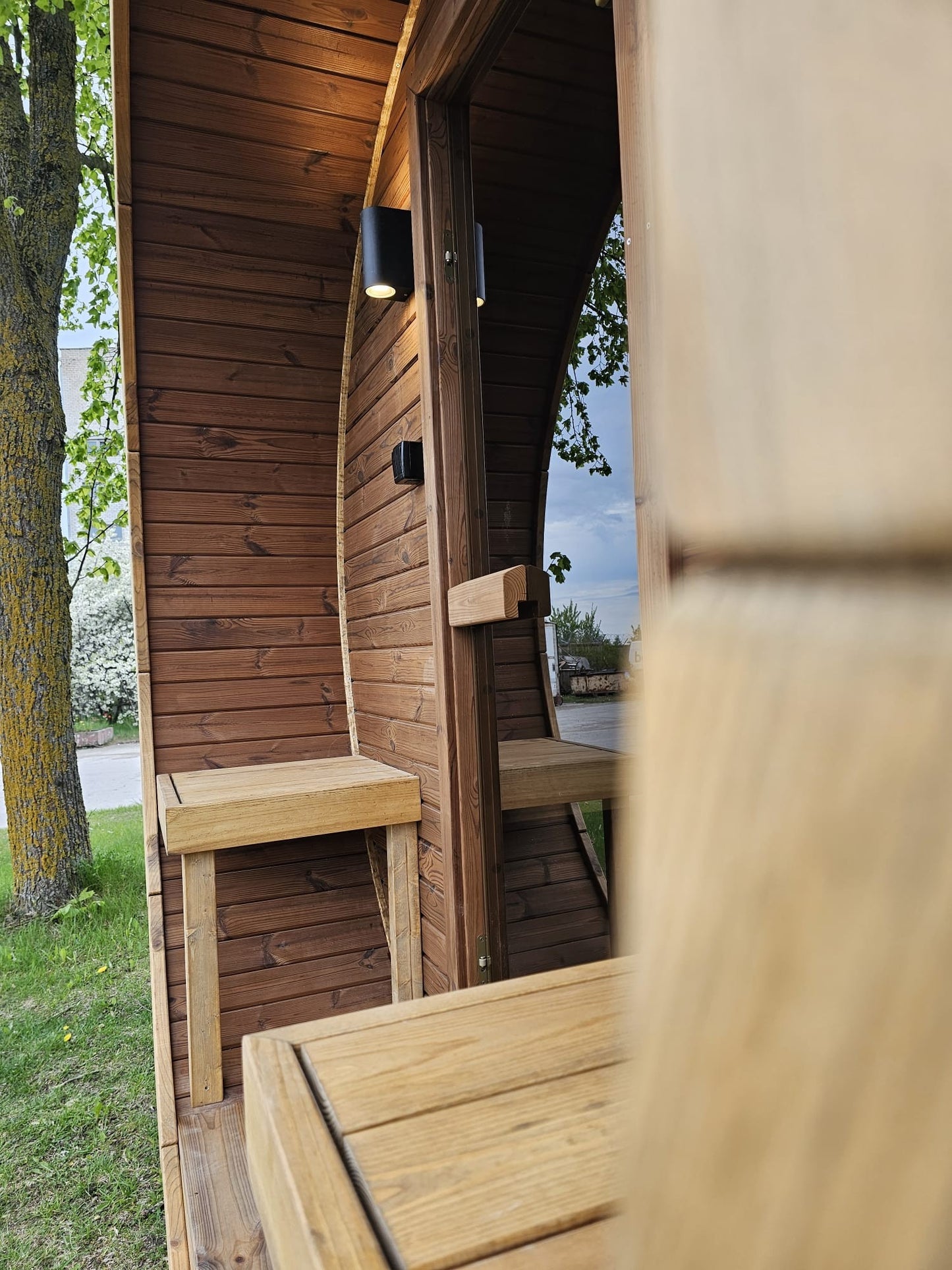 Vanne barrel sauna exterior wall lighting and porch detail