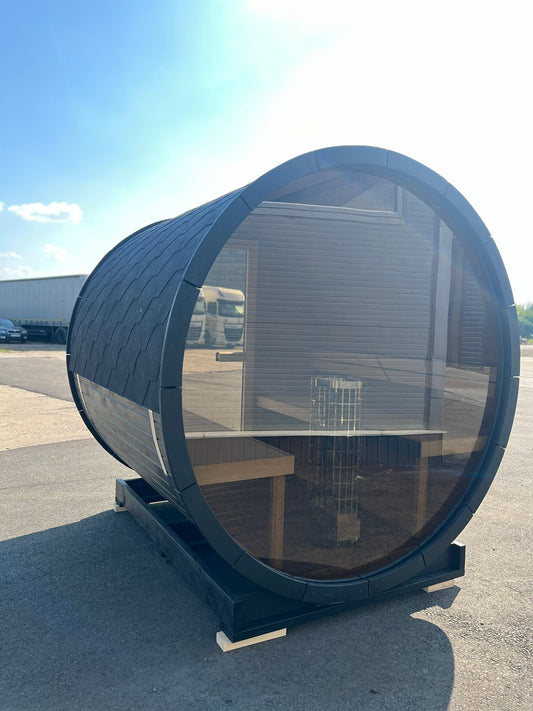 Steam and Oak Hiili 2m black thermowood barrel sauna in a UK garden