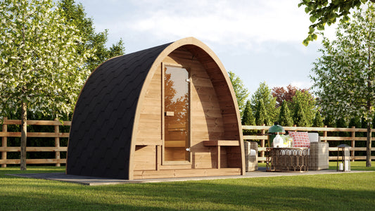Steam & Oak Kelo 220 arched sauna pod in a garden setting, shingled roof sweeping to the ground