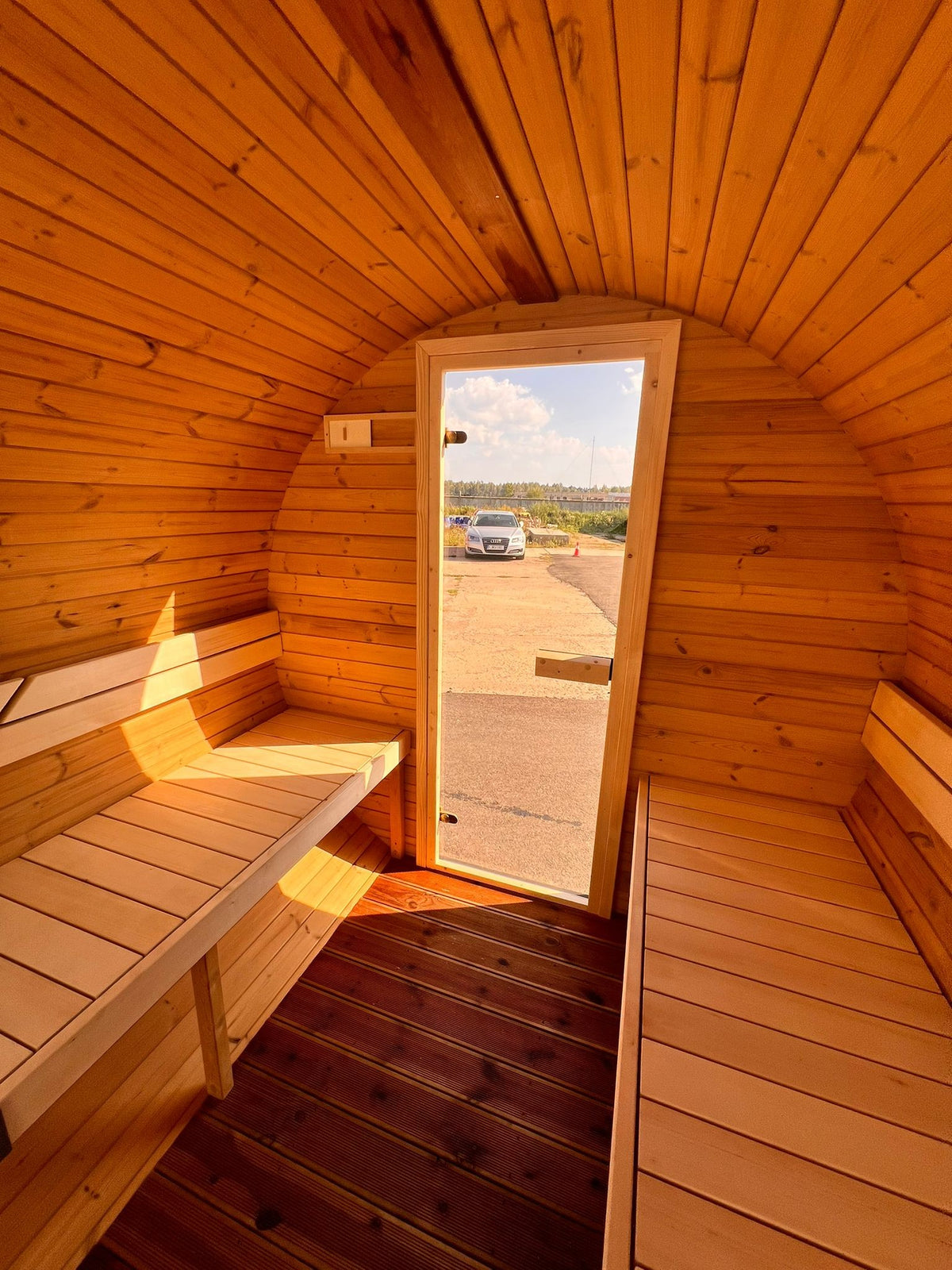 Hiili barrel sauna interior looking towards the glazed door