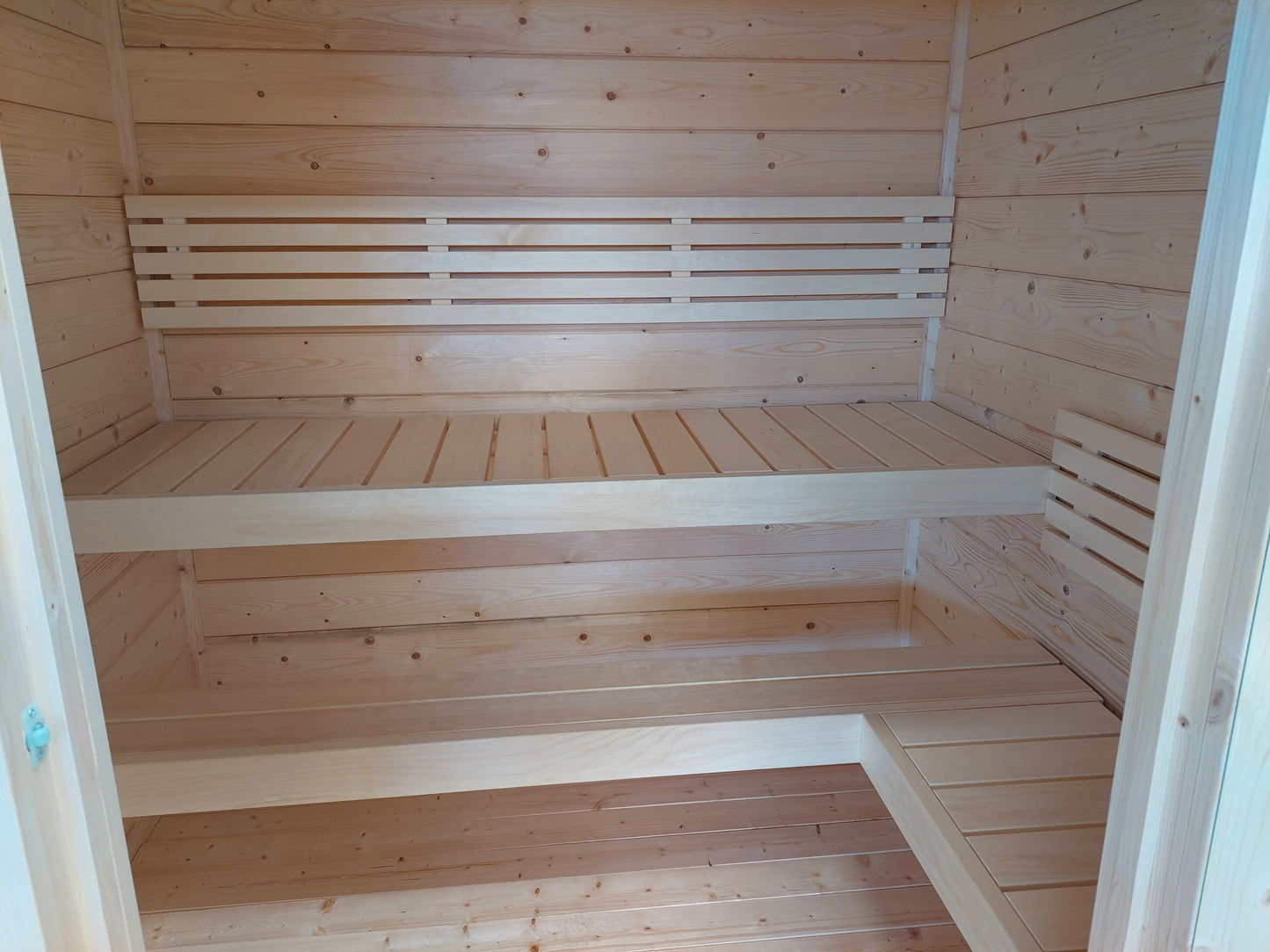 Honka 180 sauna cabin interior, showing benches and heater