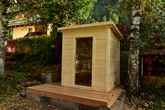 Steam & Oak Honka 180 sauna cabin installed on a timber deck in a hillside garden