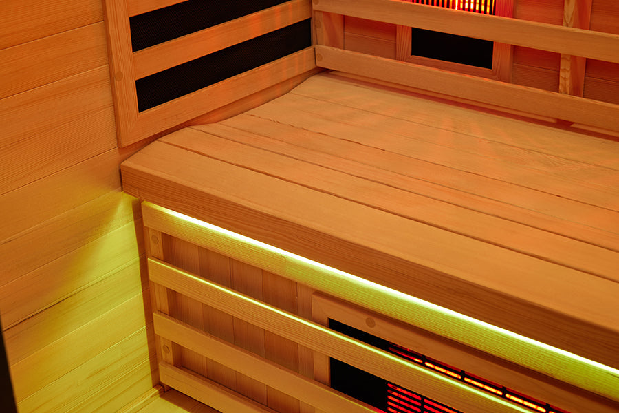 Corner view inside the infrared sauna with the backrest and side emitter