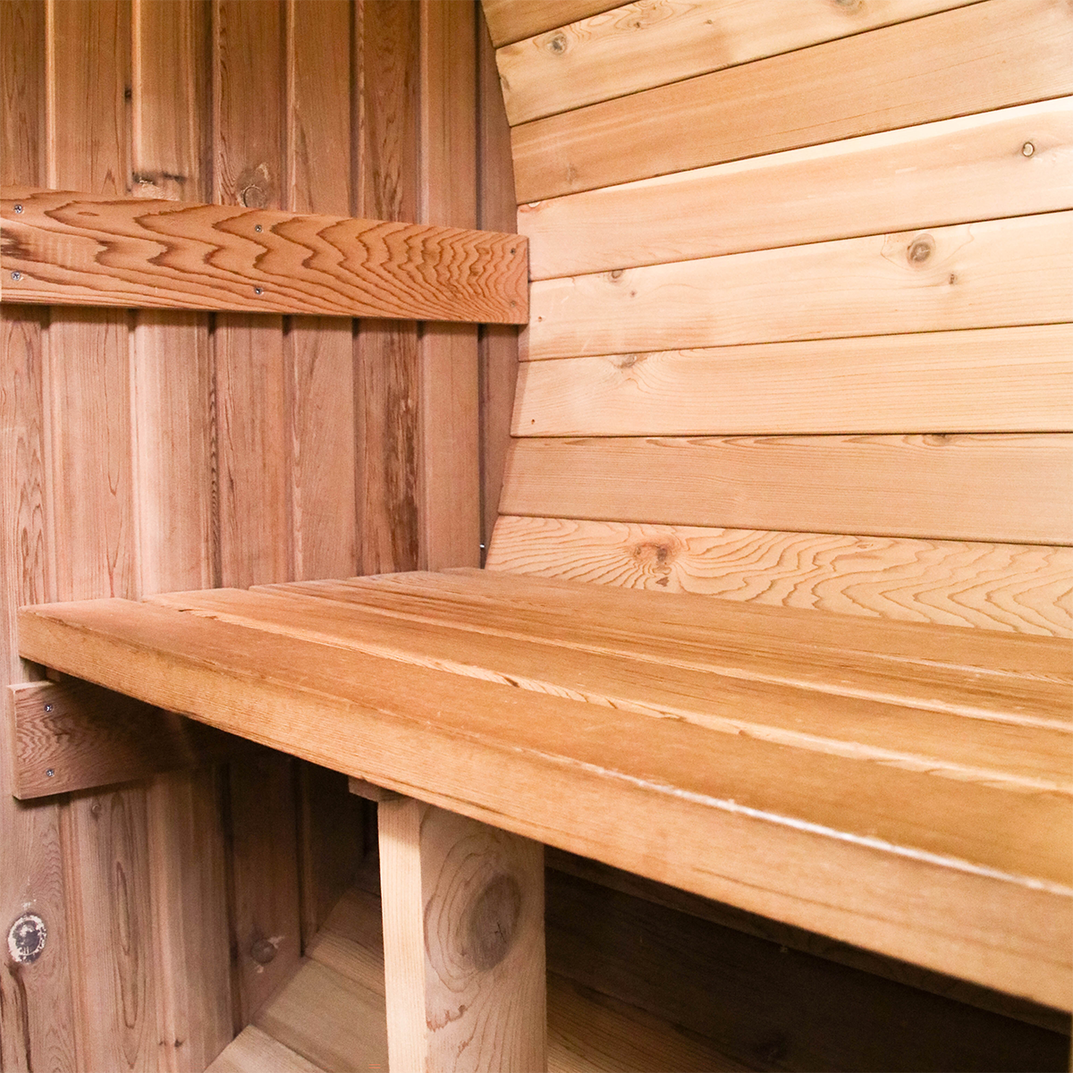 Interior of the two person barrel sauna showing the bench and heater
