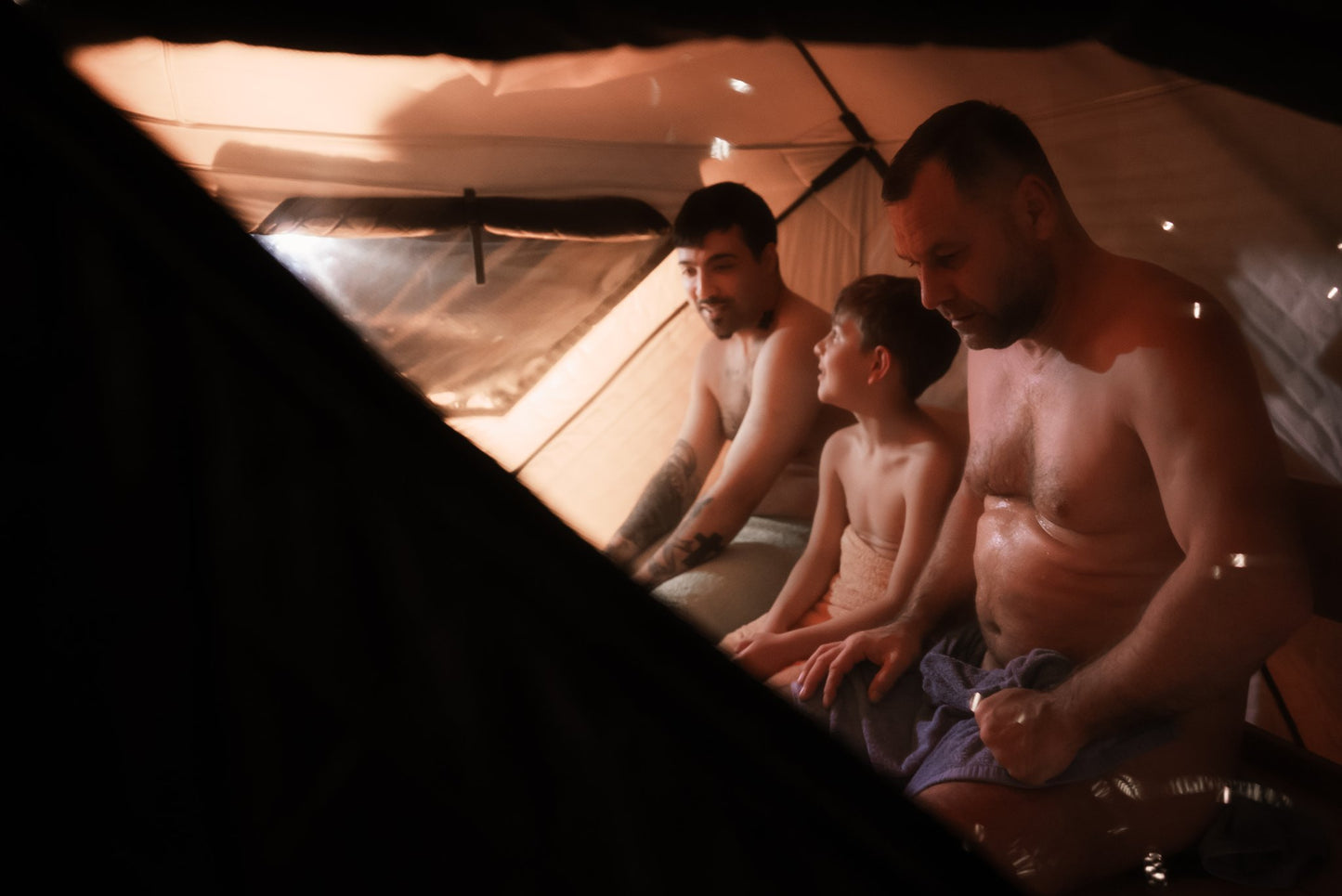 People enjoying a FinSteam portable gas sauna outdoors