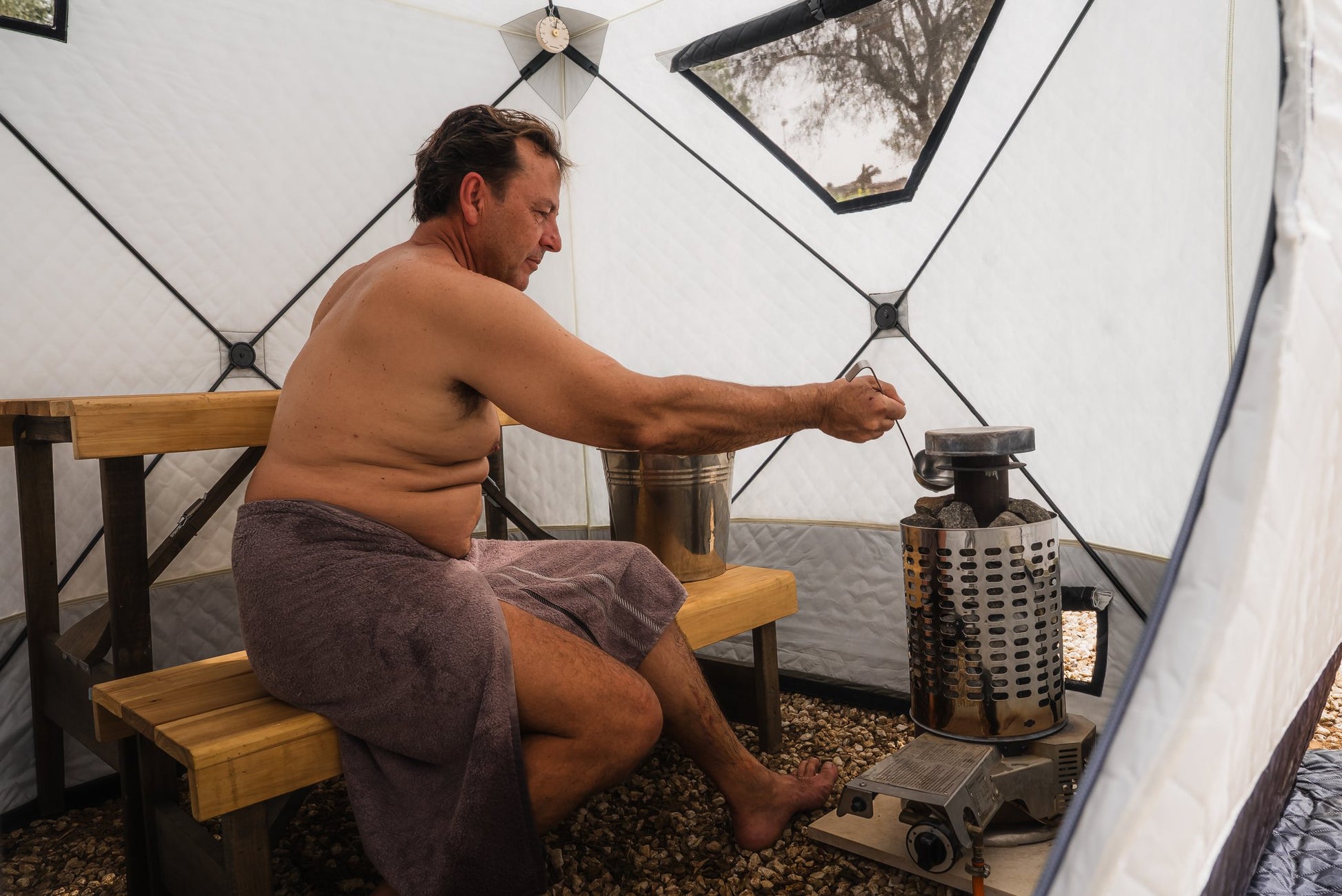 People enjoying a FinSteam portable gas sauna outdoors