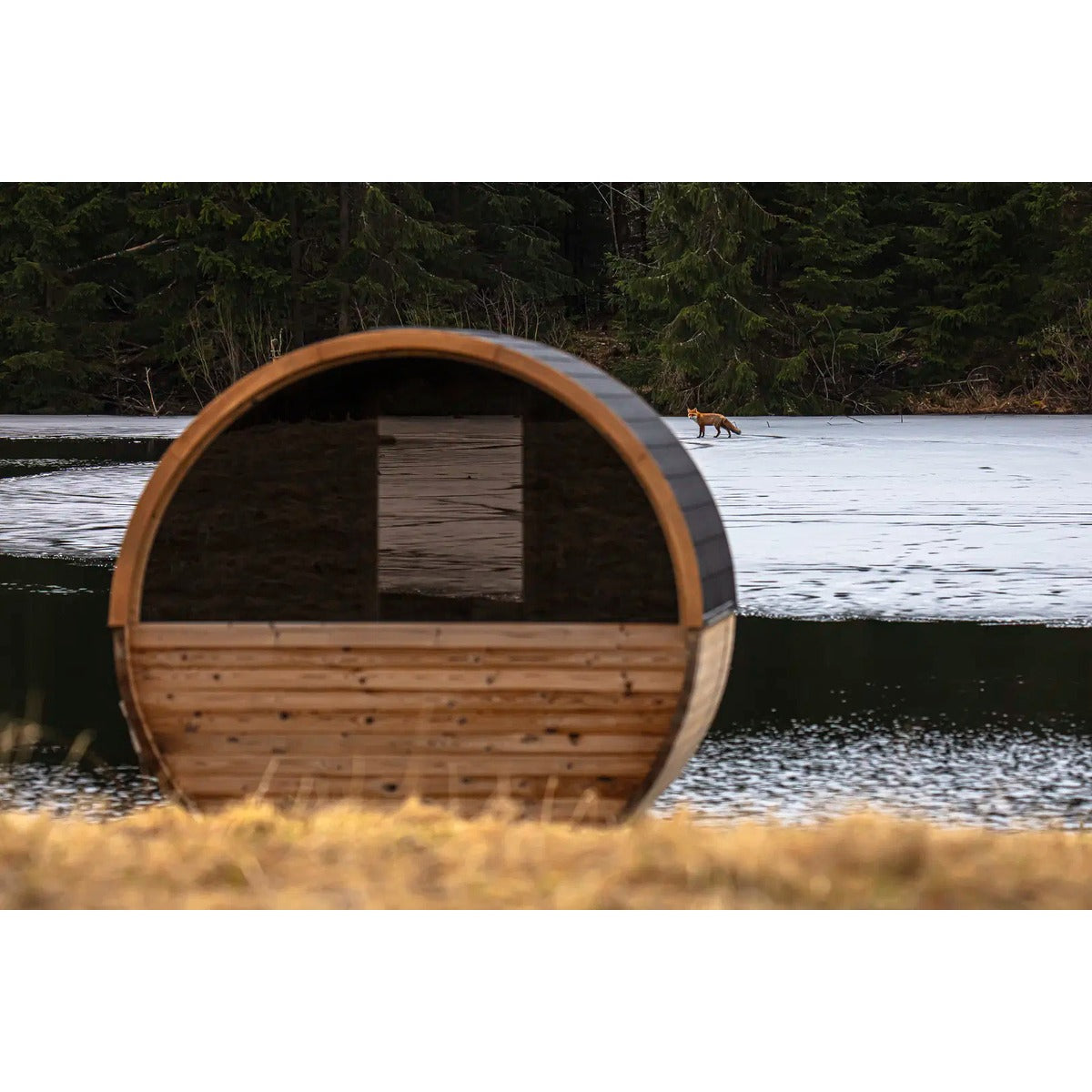 Hekla Barrel Sauna 250 rear view by a lake (lifestyle image).