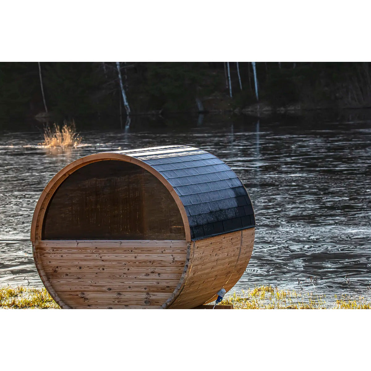 Hekla Barrel Sauna 250 rear view by a lake with multiple units (lifestyle image).