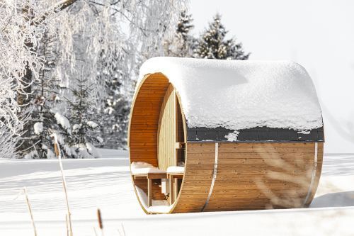 Hekla Barrel Sauna 250 outdoor barrel sauna in snowy setting (lifestyle image).