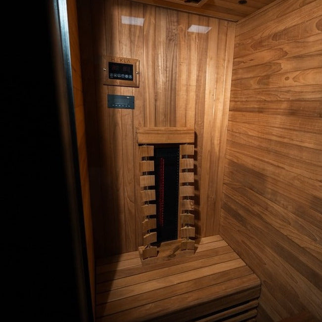 Interior wide view showing controls and heater inside the Hekla IR100 sauna.