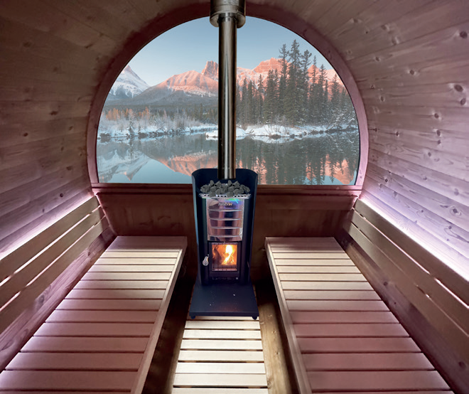 Holl's Onyxia Barrel black ThermoWood barrel sauna with chimney on a stone patio