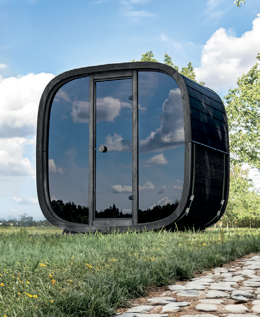 Holl's Onyxia Cube outdoor sauna with mirrored glass facade reflecting sky in a field