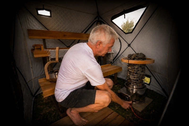 Lighting the gas sauna heater inside a FinSteam Fritid pop-up sauna tent