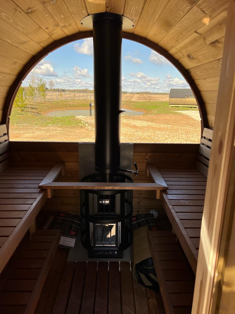 Saaren 400 Panorama thermowood barrel sauna in a garden setting