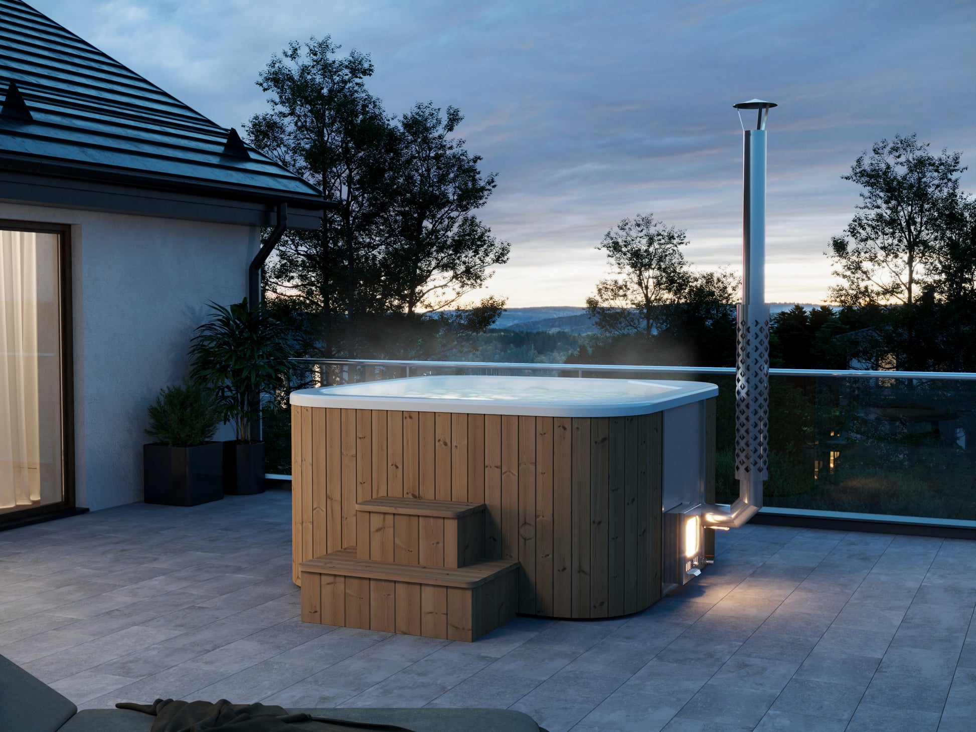Steam & Oak Hehku 1500 wood-fired hot tub on a terrace at dusk, stove lit