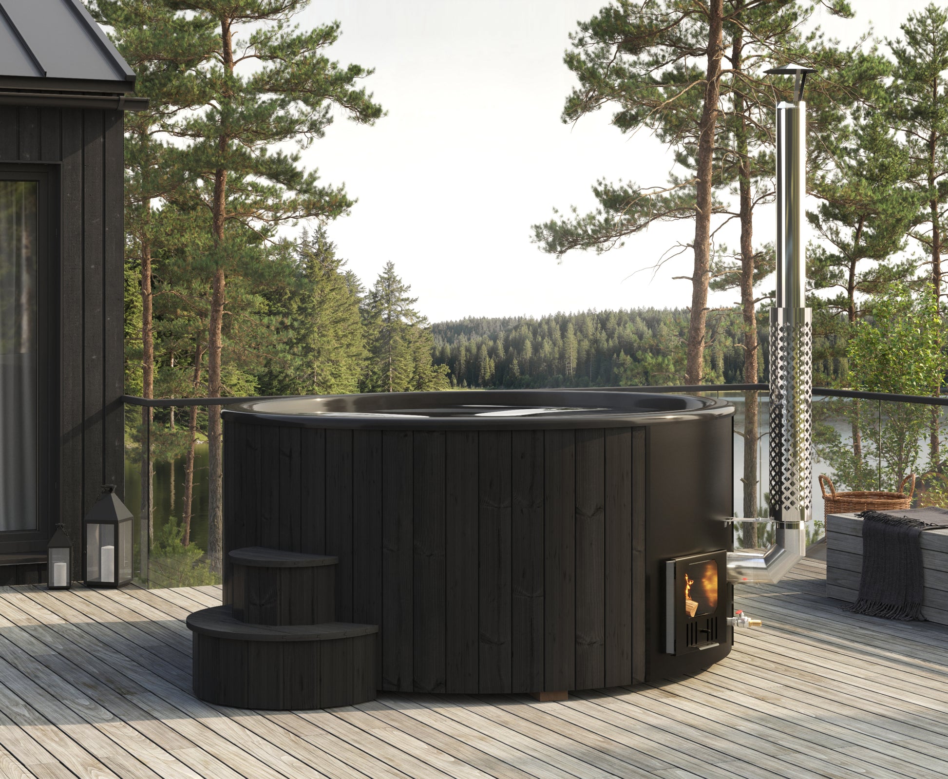 Steam & Oak Hehku 1650 XL wood-fired hot tub in black on a lakeside deck, stove lit